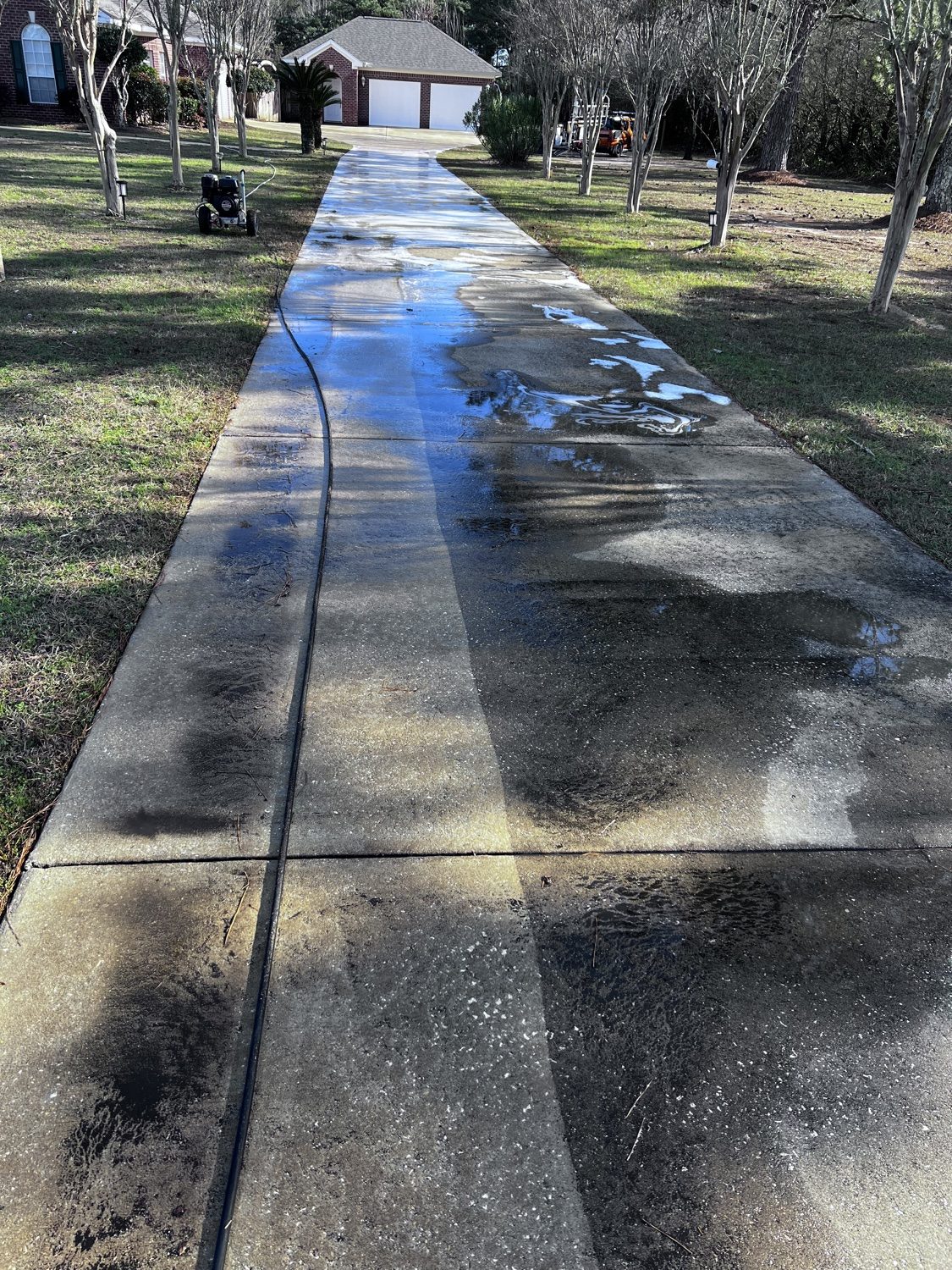 Driveway half pressure washed showing before and after in one pass