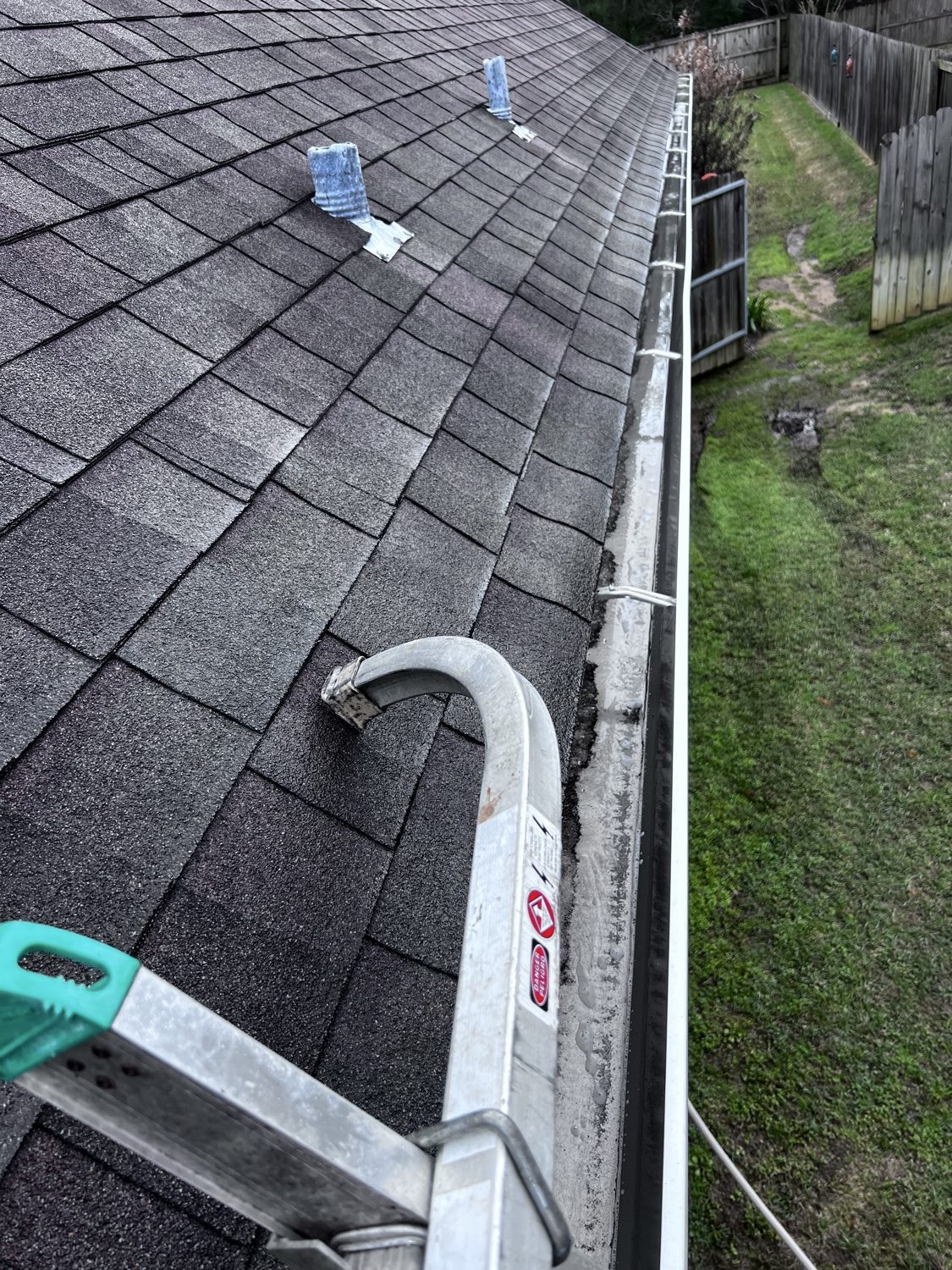 Gutter packed with debris before cleaning