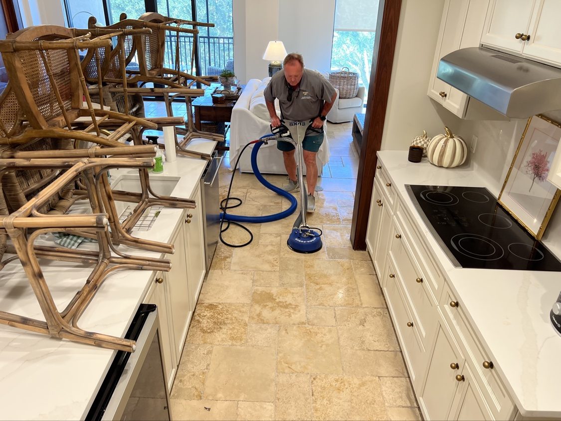 Rotary tile cleaner restoring a travertine kitchen floor